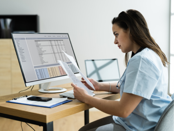 woman looking at documents reading about the intended role of TPAs for hearing aid benefits